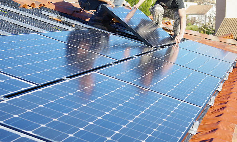 Ouvriers installant des panneaux solaires photovoltaïques.